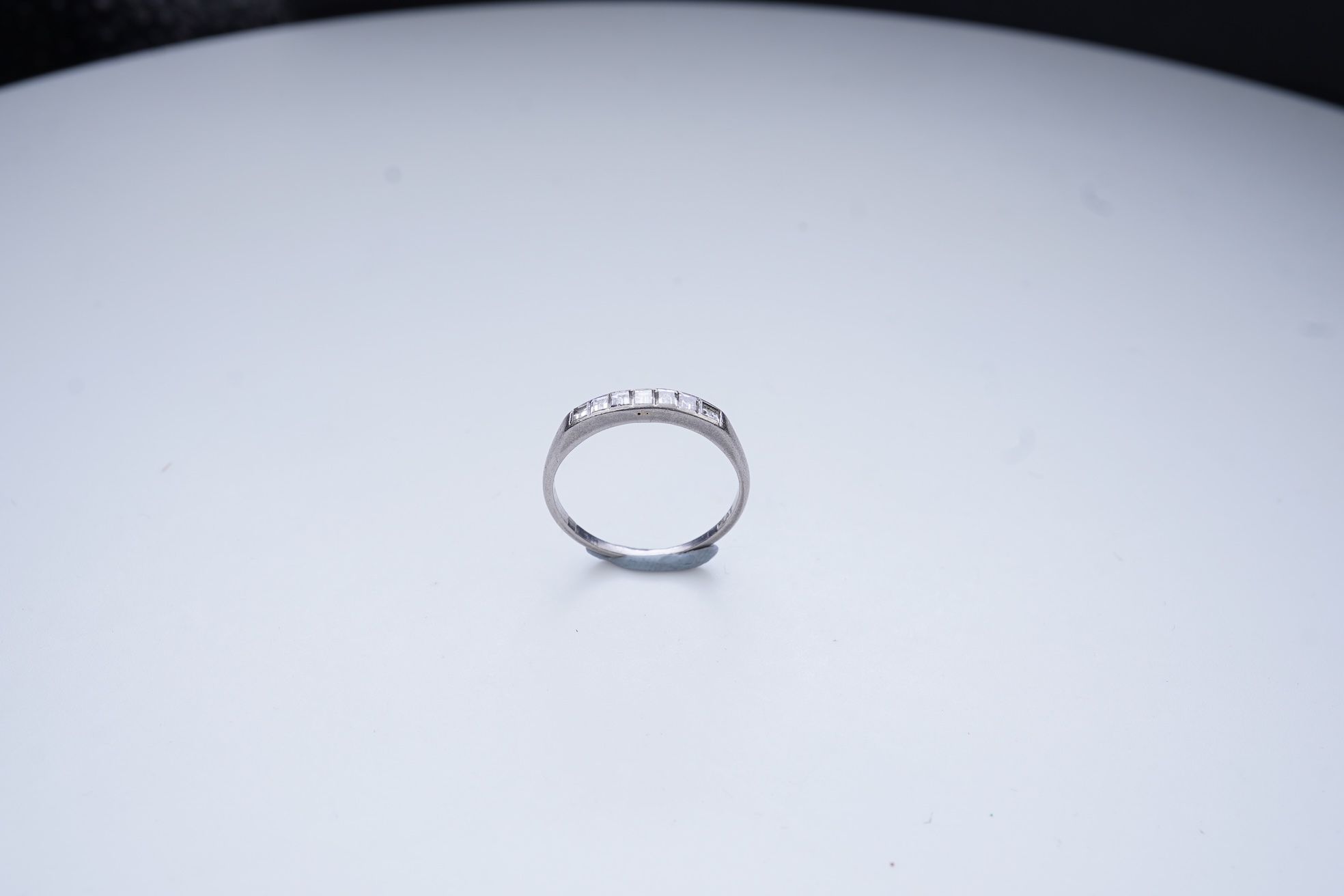A diamond half-eternity ring, first half 20th century